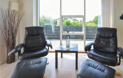 two leather chairs and a table in a living room at Three-Bedroom Holiday Home In Vestervig in Vestervig