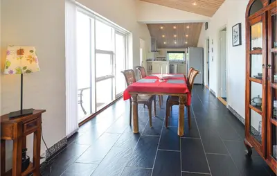 a dining room with a red table and chairs at Three-Bedroom Holiday Home In Vestervig in Vestervig