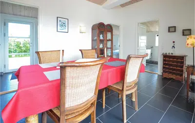 a dining room with a red table and chairs at Three-Bedroom Holiday Home In Vestervig in Vestervig