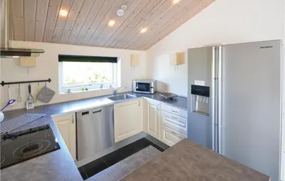 a kitchen with a refrigerator and a sink at Three-Bedroom Holiday Home In Vestervig in Vestervig