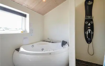 a bathroom with a toilet and a bath tub at Three-Bedroom Holiday Home In Vestervig in Vestervig