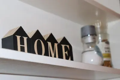 a shelf with a sign that says home on it at Holstebro Townside House in Holstebro