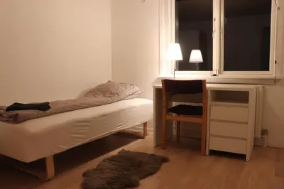 a bedroom with a bed and a desk and a chair at Holstebro Townside House in Holstebro