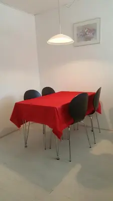 a table with chairs and a red table cloth on it at Holstebro Townside House in Holstebro