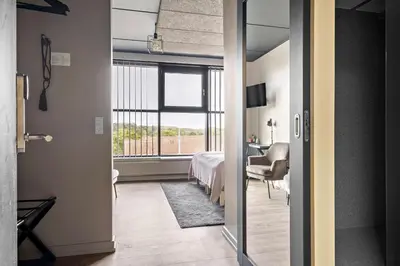 a room with a bedroom with a bed and a window at Best Western Royal Holstebro in Holstebro