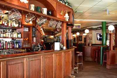 a bar with wooden walls and a bar with alcohol at Hotel Schaumburg in Holstebro