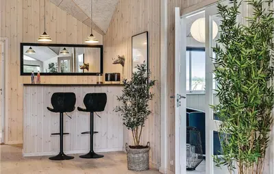 a room with two bar stools and a mirror at Nice Home In Spøttrup With Sauna in Spottrup