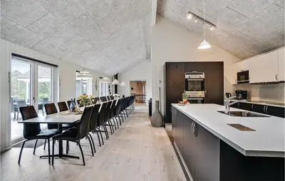 a kitchen and dining room with a table and chairs at Nice Home In Spøttrup With Sauna in Spottrup
