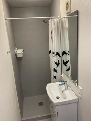 a bathroom with a shower curtain and a sink at Malthe Bruuns Vej 17, 1. sal in Thisted