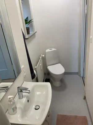 a bathroom with a white sink and a toilet at Malthe Bruuns Vej 17, 1. sal in Thisted