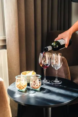a person pouring wine into glasses on a table at Struer Grand Hotel in Struer