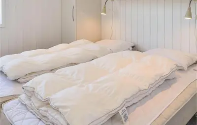 three white beds are lined up in a room at Three-Bedroom Holiday Home In Harboore in Harboør