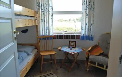 a small room with a bunk bed and a table at Five-Bedroom Holiday Home In Thisted in Thisted