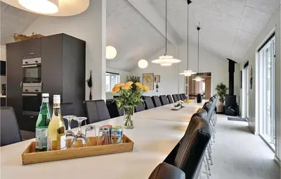 a conference room with a long table with bottles of wine at Lovely Home In Spøttrup With Sauna in Spottrup