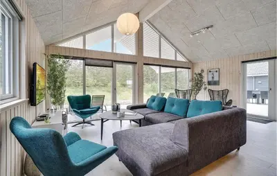 a living room with a couch and chairs at Lovely Home In Spøttrup With Sauna in Spottrup