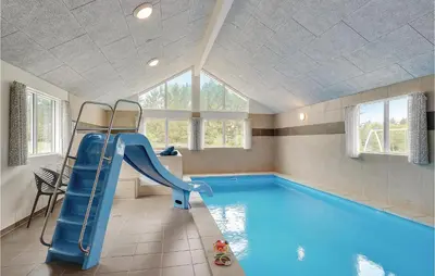 a swimming pool with a slide in a house at Lovely Home In Spøttrup With Sauna in Spottrup