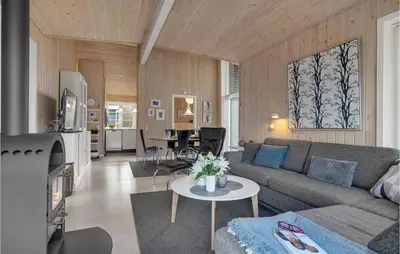 a living room with a couch and a table at Three-Bedroom Holiday Home In Logstor in Løgstør