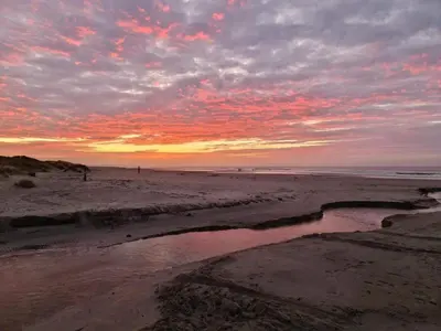 a sunset on a beach with a body of water at Secluded Beach Retreat in Rodhus-By Traum in Pandrup