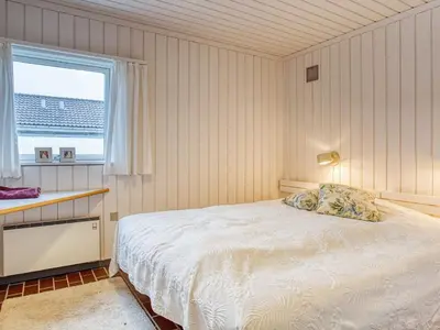 a bedroom with a bed and a window at Secluded Beach Retreat in Rodhus-By Traum in Pandrup