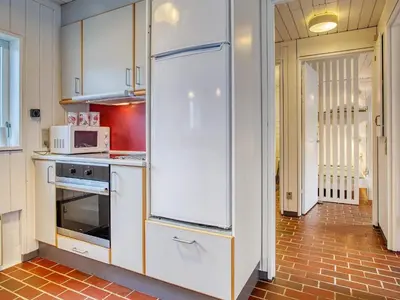 a kitchen with a white refrigerator in a room at Secluded Beach Retreat in Rodhus-By Traum in Pandrup