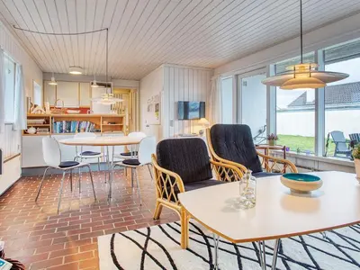 a living room with two tables and chairs at Secluded Beach Retreat in Rodhus-By Traum in Pandrup
