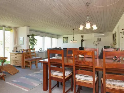a dining room with a wooden table and chairs at 6 person holiday home in Farsø-By Traum in Farsø