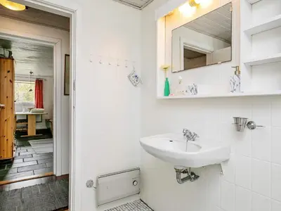 a white bathroom with a sink and a mirror at 6 person holiday home in Farsø-By Traum in Farsø