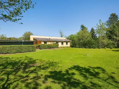 a house in a yard with a green lawn at 6 person holiday home in Farsø-By Traum in Farsø