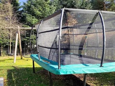 a swing set with a net on a playground at Spacious Family Retreat - By Traum Ferienwohnungen in Skals
