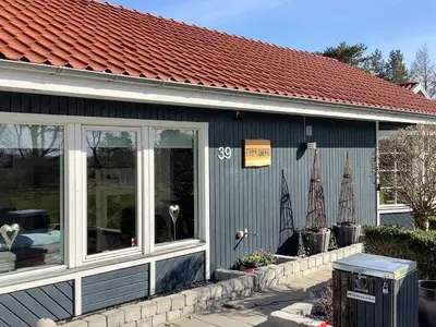 a blue building with sails on the side of it at Spacious Family Retreat - By Traum Ferienwohnungen in Skals