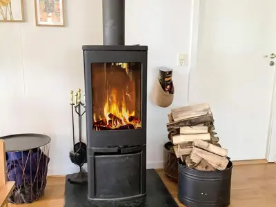 a stove with a fire in a room at Spacious Family Retreat - By Traum Ferienwohnungen in Skals