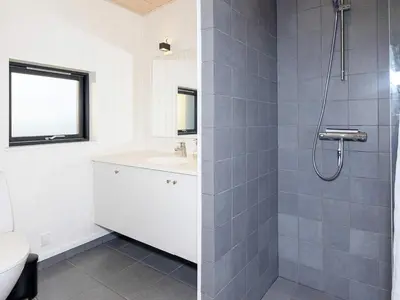 a bathroom with a sink and a shower at Modern Retreat with View - By Traum Ferienwohnungen in Løgstrup