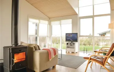 a living room with a wood stove and a tv at Three-Bedroom Holiday Home In Lemvig in Lemvig