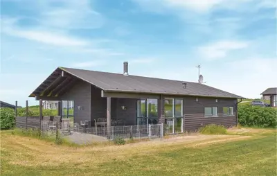 a house on a hill with a yard at Three-Bedroom Holiday Home In Lemvig in Lemvig
