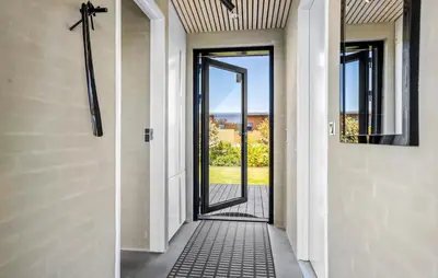 a hallway with a door with a view of the ocean at Two-Bedroom Holiday Home In Vinderup in Vinderup
