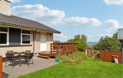 a patio with a table and chairs next to a house at Three-Bedroom Holiday Home In Fur in Fur