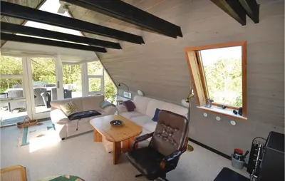 a living room with a couch and a table at Two-Bedroom Holiday Home In Logstor in Løgstør