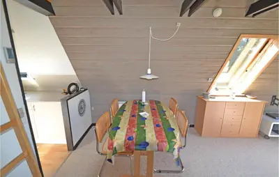 a dining room with a table and chairs at Two-Bedroom Holiday Home In Logstor in Løgstør