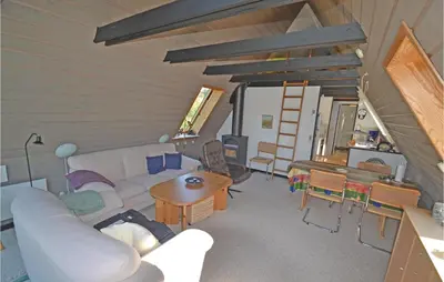 a living room with a white couch and a table at Two-Bedroom Holiday Home In Logstor in Løgstør