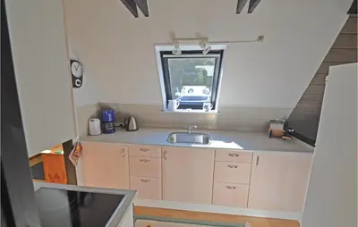 a small kitchen with a sink and a window at Two-Bedroom Holiday Home In Logstor in Løgstør
