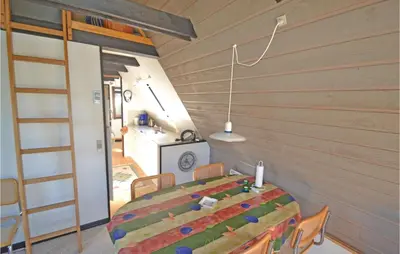 a room with a table and chairs in a room at Two-Bedroom Holiday Home In Logstor in Løgstør