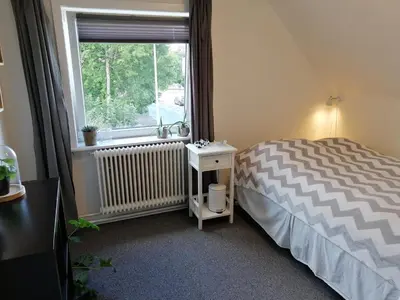a bedroom with a bed and a window at Bed and Breakfast i Struer in Struer
