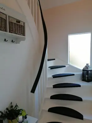 a staircase in a house with black and white stairs at Bed and Breakfast i Struer in Struer