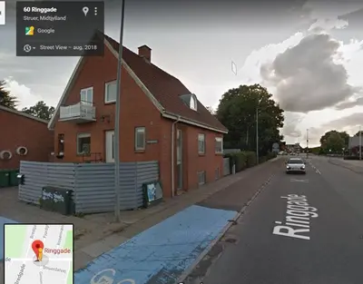 a car driving down a street next to a house at Bed and Breakfast i Struer in Struer