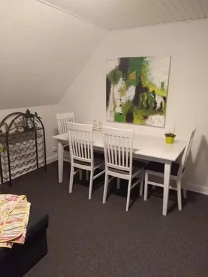 a dining room with a white table and chairs at Bed and Breakfast i Struer in Struer