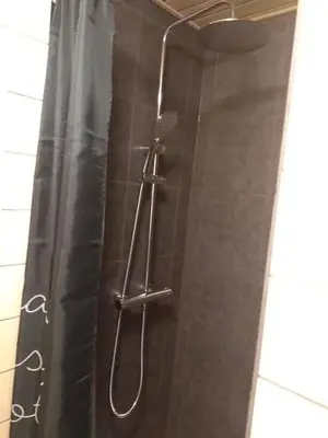 a shower with a shower head and a shower curtain at Bed and Breakfast i Struer in Struer