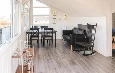 a living room with a dining room table and chairs at Two-Bedroom Holiday Home In Lemvig in Lemvig