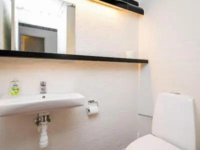 a bathroom with a sink and a toilet and a mirror at 6 person holiday home in Brovst-By Traum in Brovst