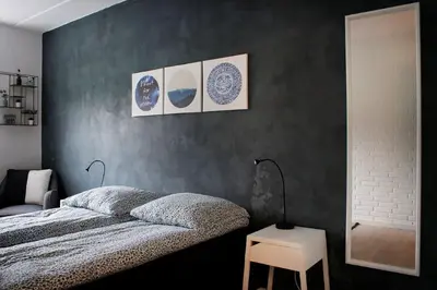 a bedroom with a bed and three plates on the wall at Nordkap Bed & Bath in Holstebro