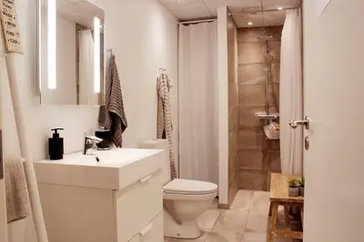 a bathroom with a sink and a toilet and a shower at Nordkap Bed & Bath in Holstebro